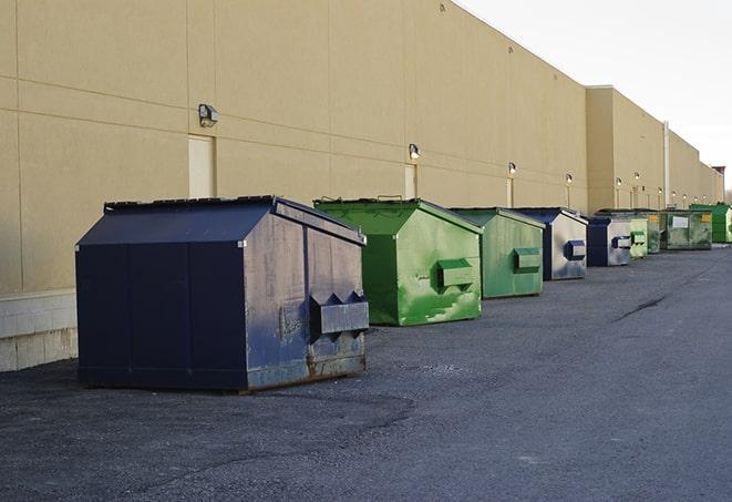 construction workers disposing of debris in large dumpsters in Altadena, CA